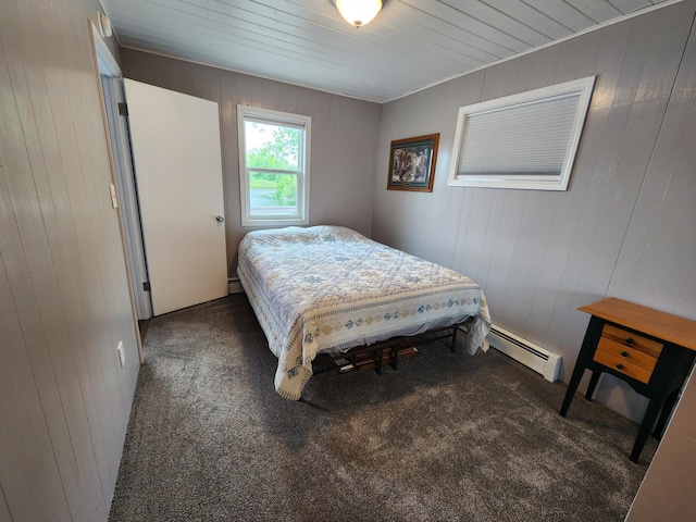 207 Mill Rd, Park Rapids, MN 56470 - bedroom featuring a baseboard radiator, carpet floors, and wooden walls