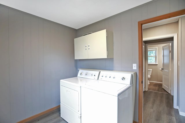 913 12th Ave SE, Austin, MN 55912 - laundry area featuring cabinet space, dark wood-type flooring, and washing machine and clothes dryer