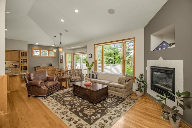 485 Preserve Path W, Saint Paul, MN 55118 - living room with light wood finished floors, lofted ceiling, a tile fireplace, and recessed lighting