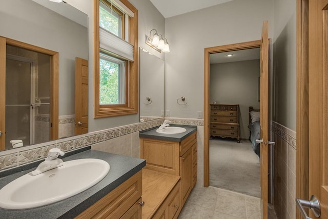 485 Preserve Path W, Saint Paul, MN 55118 - ensuite bathroom with tile patterned flooring, tile walls, two vanities, and a wainscoted wall