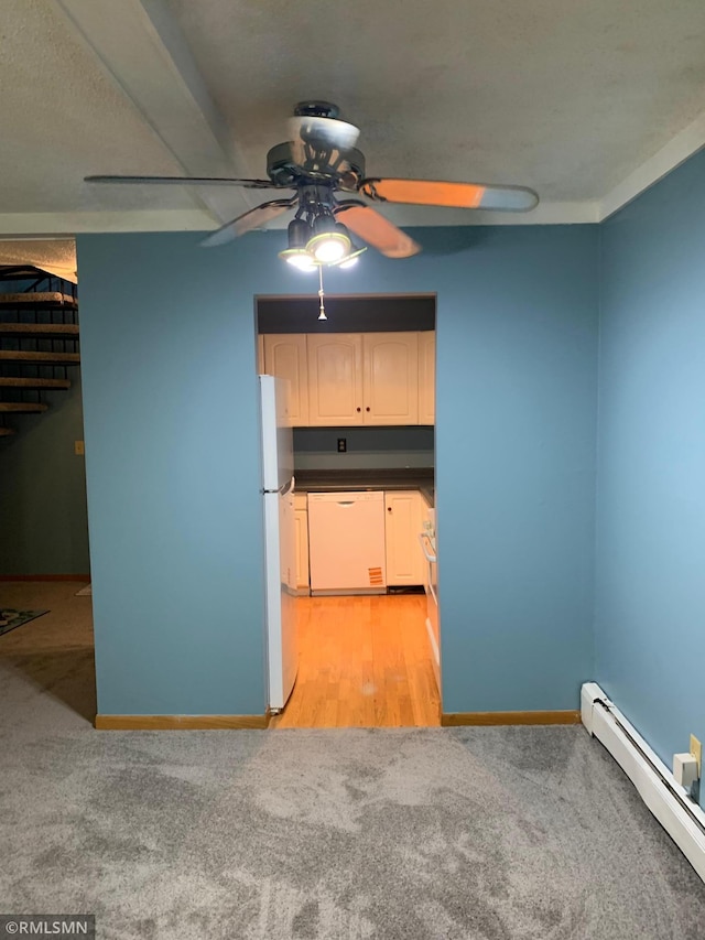 7236 72nd Ln N Unit 202, Brooklyn Park, MN 55428 - kitchen featuring white appliances, a baseboard heating unit, a ceiling fan, light carpet, and dark countertops