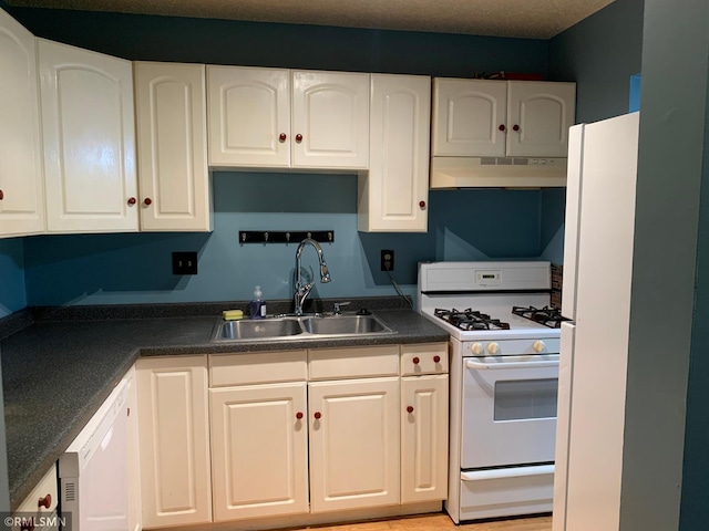 7236 72nd Ln N Unit 202, Brooklyn Park, MN 55428 - kitchen featuring under cabinet range hood, white appliances, dark countertops, and white cabinets