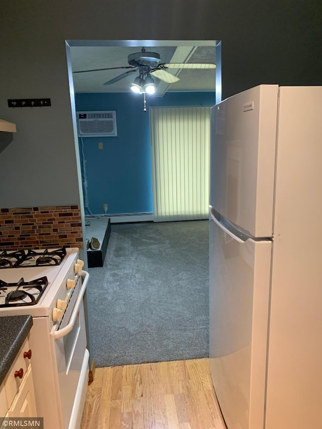 7236 72nd Ln N Unit 202, Brooklyn Park, MN 55428 - kitchen with white appliances, a wall unit AC, a ceiling fan, decorative backsplash, and dark countertops