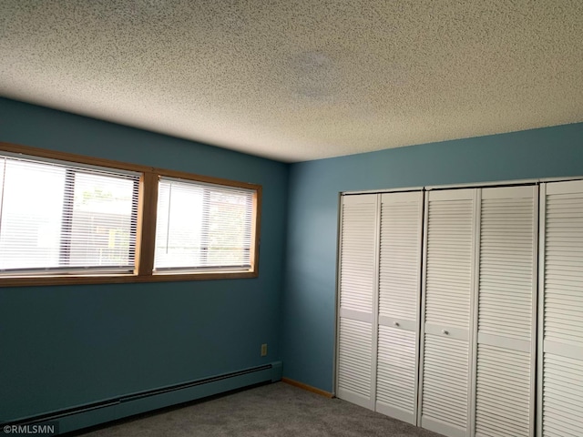 7236 72nd Ln N Unit 202, Brooklyn Park, MN 55428 - unfurnished bedroom featuring a baseboard radiator, carpet flooring, a textured ceiling, and a closet