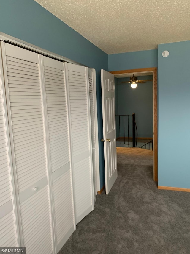 7236 72nd Ln N Unit 202, Brooklyn Park, MN 55428 - hallway featuring dark carpet and a textured ceiling