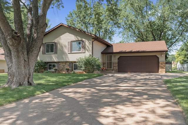 4133 88th Ave NE, Blaine, MN 55014 - tri-level home with an attached garage, driveway, brick siding, and a front lawn