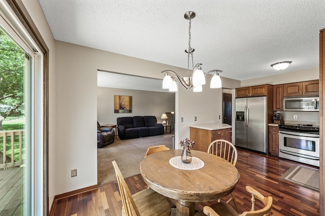 4133 88th Ave NE, Blaine, MN 55014 - dining space featuring a textured ceiling, dark wood-type flooring, and a chandelier