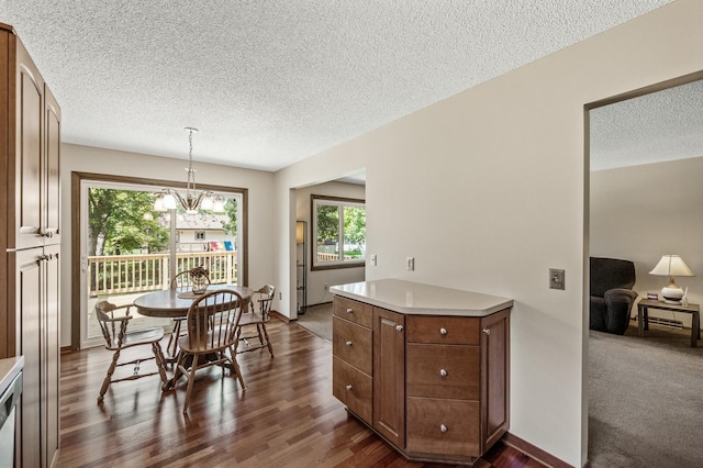 4133 88th Ave NE, Blaine, MN 55014 - dining area with a textured ceiling, plenty of natural light, dark wood finished floors, and a chandelier