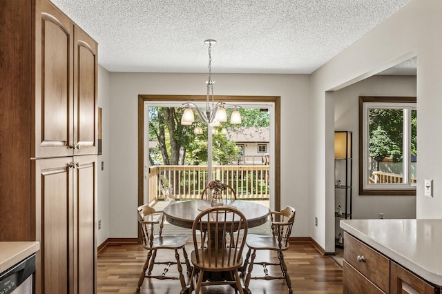 4133 88th Ave NE, Blaine, MN 55014 - dining room featuring dark wood finished floors, a textured ceiling, and a chandelier