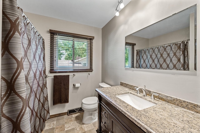 4133 88th Ave NE, Blaine, MN 55014 - bathroom featuring vanity, healthy amount of natural light, stone finish floors, and curtained shower
