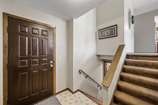 4133 88th Ave NE, Blaine, MN 55014 - entryway featuring a textured ceiling and stairs
