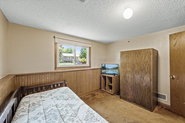 4133 88th Ave NE, Blaine, MN 55014 - carpeted bedroom with a textured ceiling, a wainscoted wall, and wooden walls