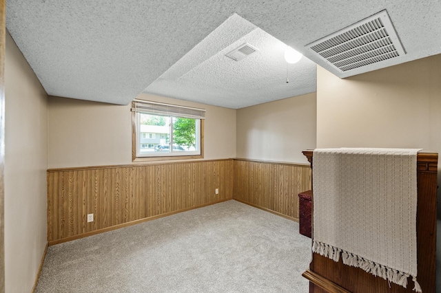 4133 88th Ave NE, Blaine, MN 55014 - carpeted spare room with a wainscoted wall, a textured ceiling, and wooden walls