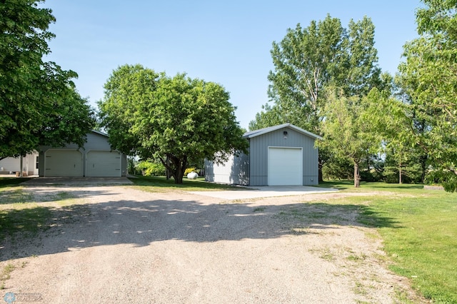 15544 60th Ave S, Riverton Twp, MN 56547 - view of front facade featuring a detached garage, an outdoor structure, and a front lawn