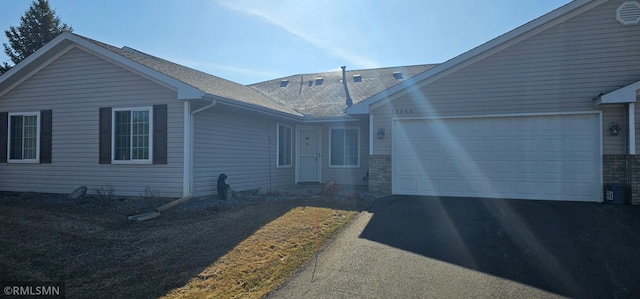 13046 Brookside Ln N, Rogers, MN 55374 - ranch-style home featuring asphalt driveway and a garage
