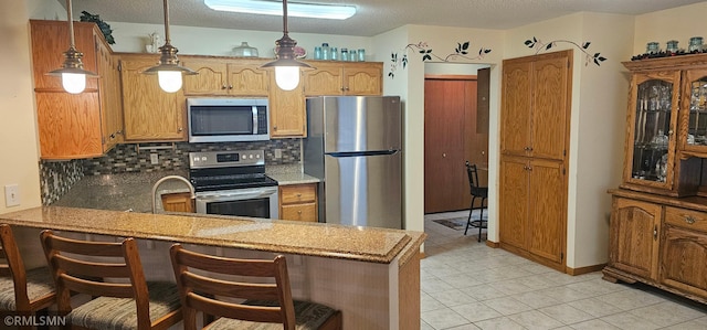 13046 Brookside Ln N, Rogers, MN 55374 - kitchen with stainless steel appliances, decorative backsplash, a peninsula, light tile patterned floors, and light countertops