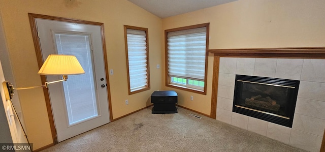 13046 Brookside Ln N, Rogers, MN 55374 - unfurnished living room featuring carpet, vaulted ceiling, and a tile fireplace