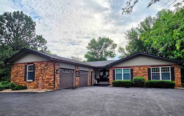 902 6th Ave SE, Pipestone, MN 56164 - ranch-style house featuring brick siding, driveway, and a garage