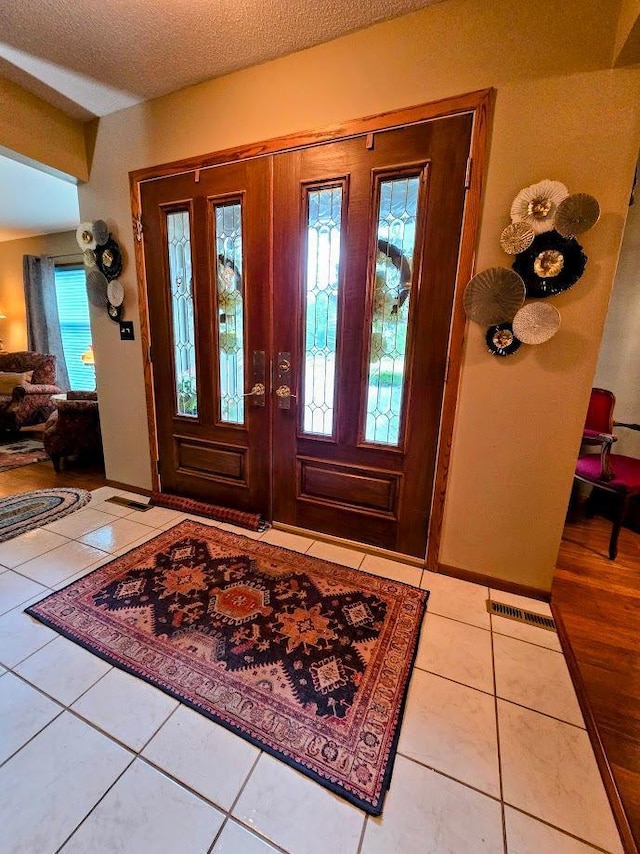 902 6th Ave SE, Pipestone, MN 56164 - entrance foyer with plenty of natural light, tile patterned flooring, and a textured ceiling