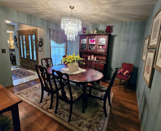 902 6th Ave SE, Pipestone, MN 56164 - dining room featuring a chandelier, wood finished floors, and a textured ceiling