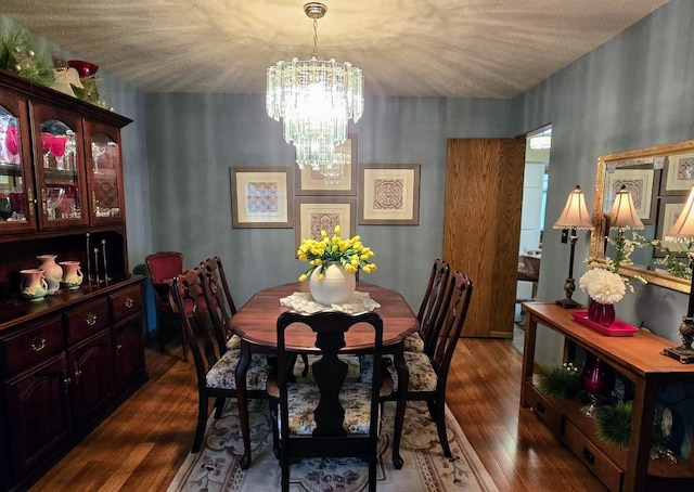 902 6th Ave SE, Pipestone, MN 56164 - dining room featuring a chandelier, dark wood-type flooring, and a textured ceiling