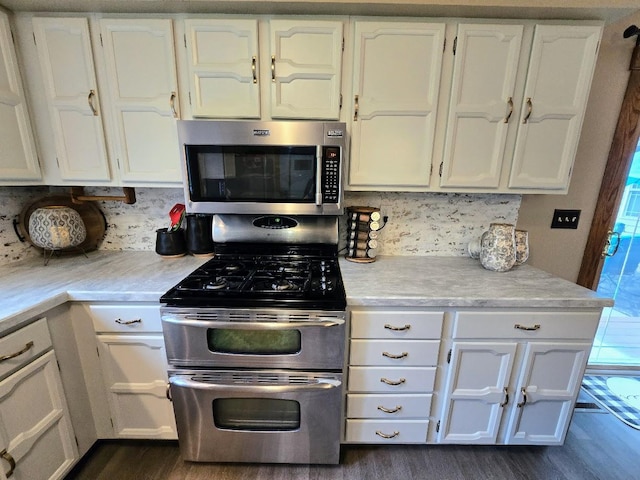 902 6th Ave SE, Pipestone, MN 56164 - kitchen featuring stainless steel appliances, white cabinets, light countertops, and dark wood-style flooring