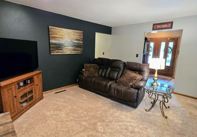 902 6th Ave SE, Pipestone, MN 56164 - living room featuring carpet and baseboards