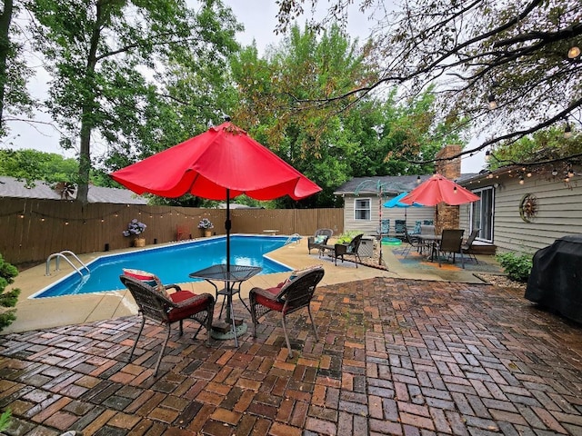 902 6th Ave SE, Pipestone, MN 56164 - view of swimming pool featuring a fenced backyard, outdoor dining space, a patio, and area for grilling