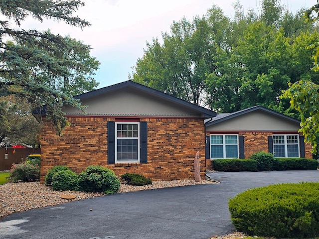 902 6th Ave SE, Pipestone, MN 56164 - view of home's exterior featuring brick siding and driveway