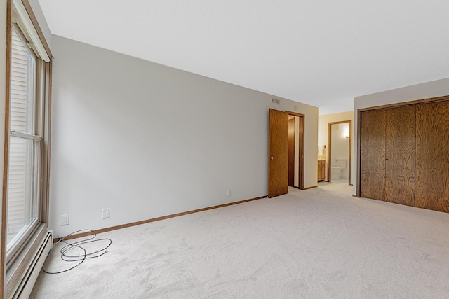 9700 Portland Ave S Unit 237, Bloomington, MN 55420 - unfurnished bedroom featuring a baseboard heating unit, light carpet, and multiple windows