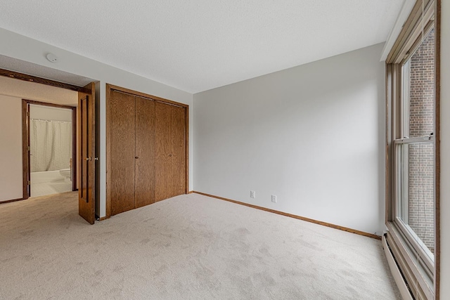 9700 Portland Ave S Unit 237, Bloomington, MN 55420 - unfurnished bedroom with a baseboard radiator, carpet flooring, and a closet