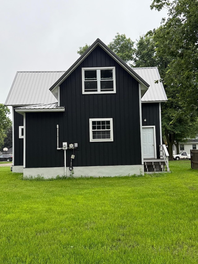 409 4th St W, Canby, MN 56220 - view of property exterior with board and batten siding, a yard, a metal roof, and a standing seam roof