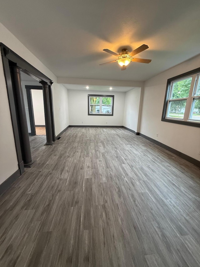 409 4th St W, Canby, MN 56220 - empty room featuring dark wood-type flooring, ceiling fan, and plenty of natural light