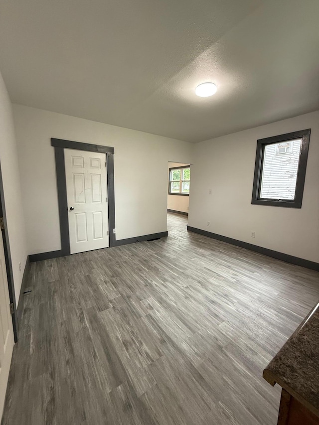 409 4th St W, Canby, MN 56220 - unfurnished room featuring wood finished floors and a textured ceiling