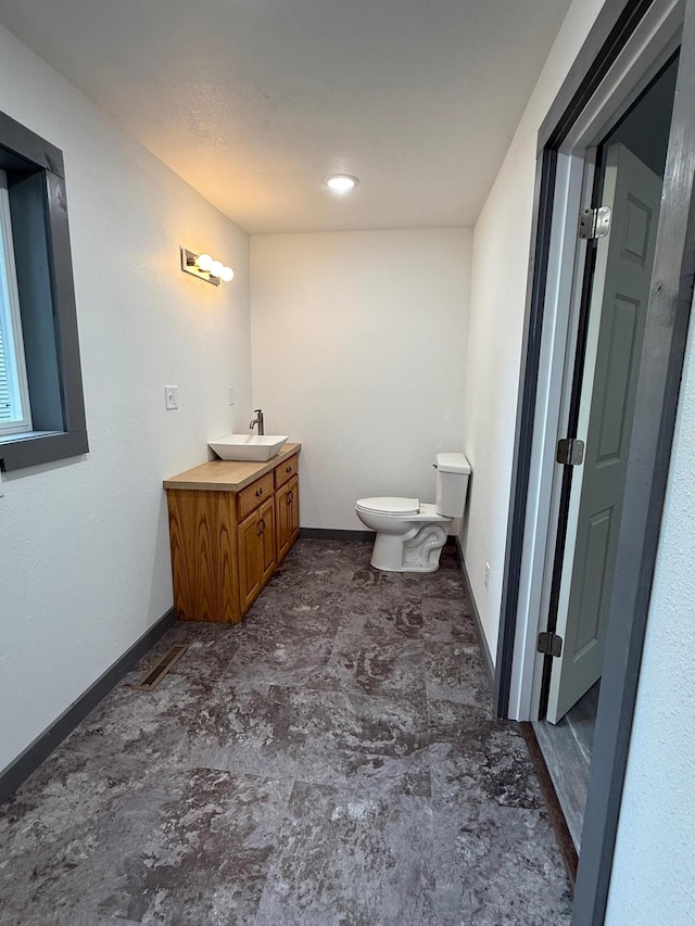 409 4th St W, Canby, MN 56220 - bathroom featuring toilet and vanity