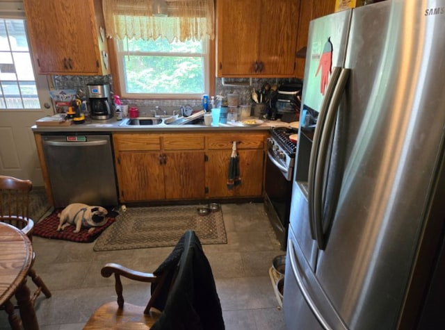 687 Dover St NE, Fridley, MN 55432 - kitchen with stainless steel appliances, brown cabinetry, and light countertops