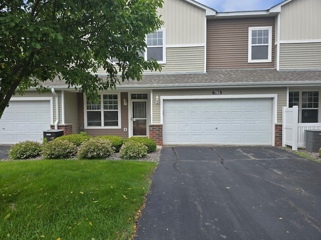 703 10th St S, Buffalo, MN 55313 - multi unit property featuring driveway, brick siding, a front yard, and a garage
