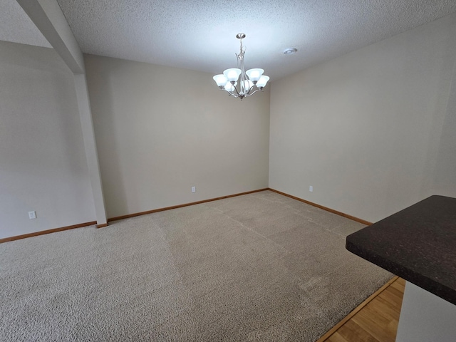 703 10th St S, Buffalo, MN 55313 - empty room with a chandelier, light colored carpet, and a textured ceiling
