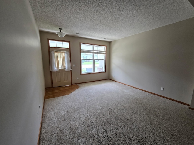 703 10th St S, Buffalo, MN 55313 - carpeted empty room with a textured ceiling and baseboards