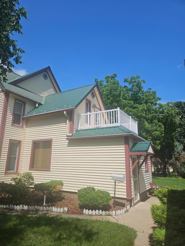 442 Cleveland Ave W, Winnebago, MN 56098 - view of side of home featuring a balcony and a metal roof