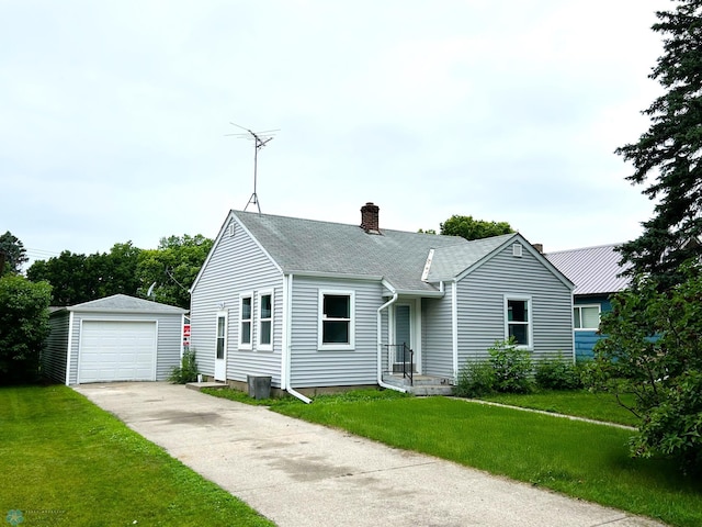 217 6th St SE, Barnesville, MN 56514 - view of front of home featuring an outbuilding, a chimney, driveway, a garage, and a front yard
