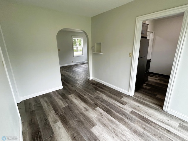 217 6th St SE, Barnesville, MN 56514 - empty room with arched walkways and dark wood-style flooring