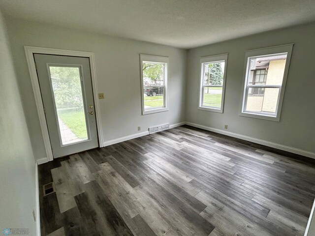 217 6th St SE, Barnesville, MN 56514 - unfurnished room featuring dark wood-type flooring and baseboards