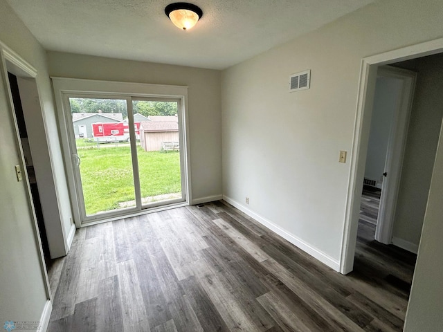 217 6th St SE, Barnesville, MN 56514 - unfurnished room featuring dark wood finished floors and baseboards