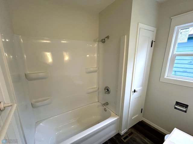 217 6th St SE, Barnesville, MN 56514 - bathroom with wood finished floors and shower / washtub combination