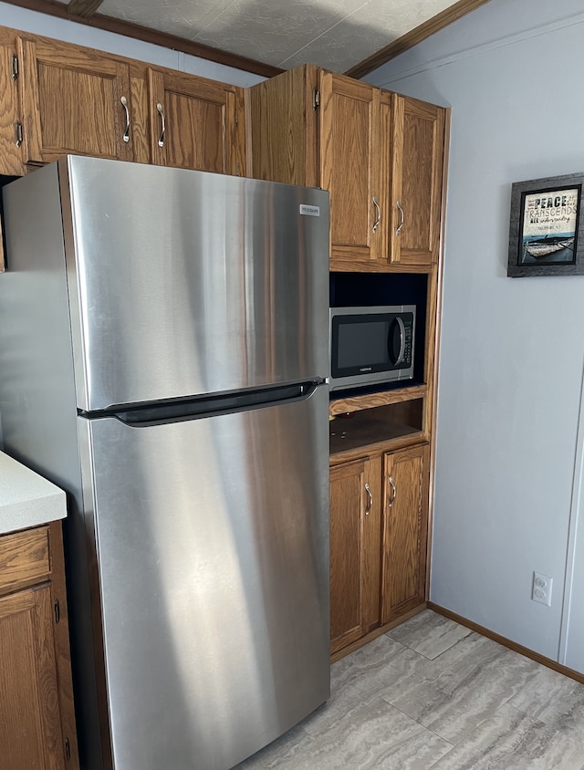 1323 Pine Tree Dr, Maplewood, MN 55119 - kitchen with stainless steel appliances, brown cabinets, and light countertops