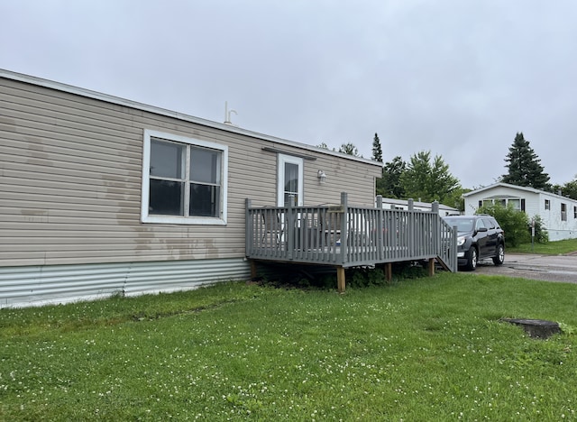 1323 Pine Tree Dr, Maplewood, MN 55119 - back of property with a deck and a lawn