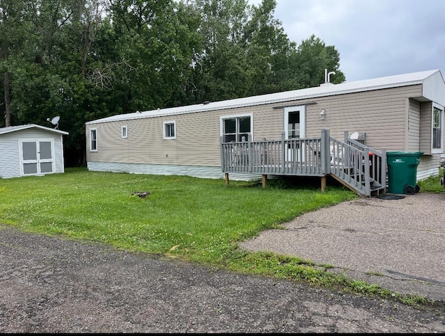 1323 Pine Tree Dr, Maplewood, MN 55119 - manufactured / mobile home with a deck, a storage shed, and a front lawn
