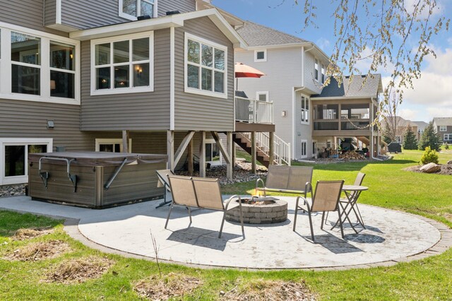 3608 Strawberry Ln, Chanhassen, MN 55331 - back of house featuring a hot tub, an outdoor fire pit, a patio, and a lawn