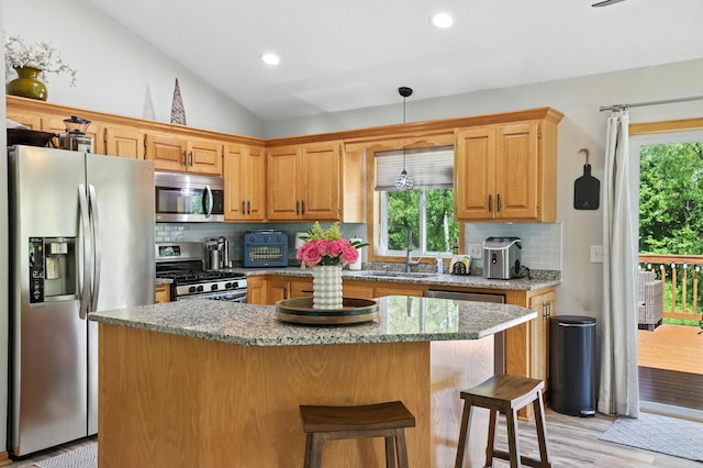 22615 Janero Ave N, Forest Lake, MN 55025 - kitchen with stainless steel appliances, backsplash, plenty of natural light, vaulted ceiling, and recessed lighting
